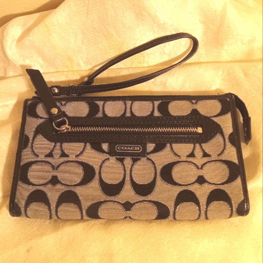 Coach canvas gray and black zip around wallet and wristlet.